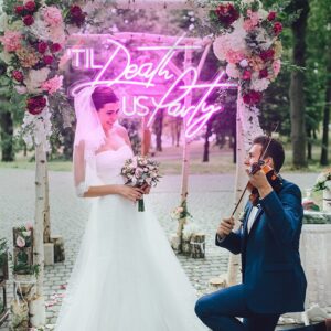 A vibrant and modern photograph of a wedding ceremony or proposal set outdoors, blending traditional romance with a contemporary touch.
