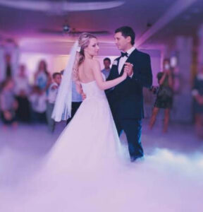 A bride and groom performing their first dance at their wedding reception.