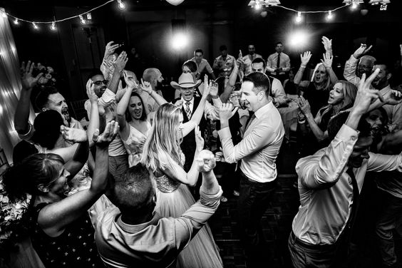 A crowded wedding party on dance floor.